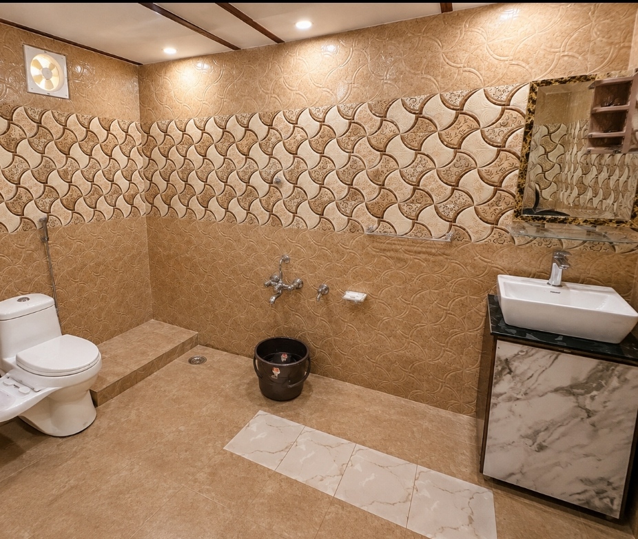 Spacious beige-tiled private suite bathroom