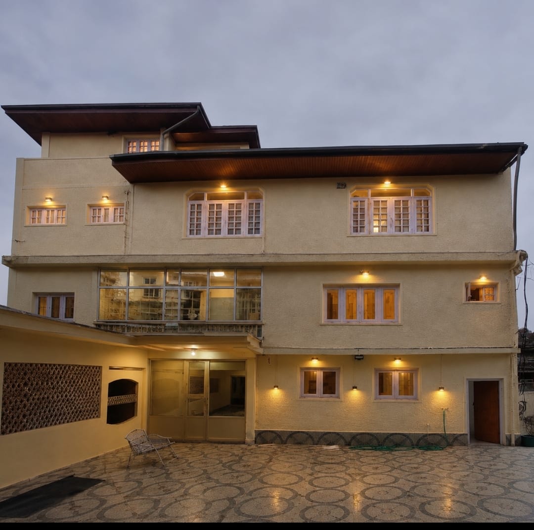 Hotel Luxury Suites Srinagar courtyard illuminated in the evening